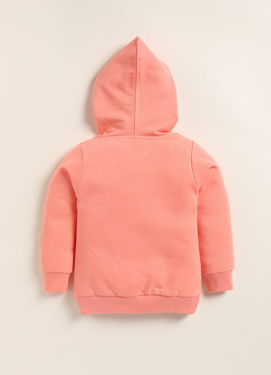 Image file 1756-Peach.jpg showing a flat lay of a peach Biskid brand girls hooded sweatshirt featuring the "Enjoy" graphic and "PERFECT STYLE" text, displayed with decorative items including children's sunglasses and a toy camera.