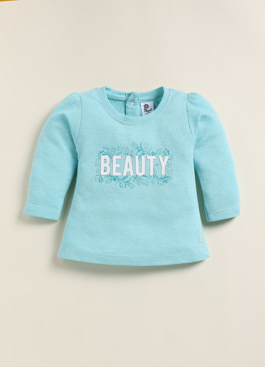Image file BG-415-SkyBlue.jpg showing a flat lay of an Annie brand girls two-piece clothing set. The outfit includes a textured sky-blue long-sleeve top with the word "BEAUTY" and floral accents, paired with matching leggings featuring a light blue and white checkerboard pattern decorated with simple flowers.