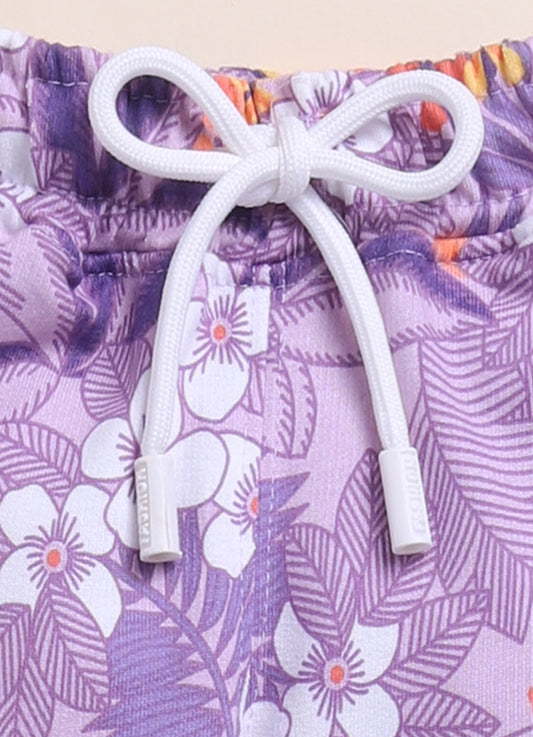 Image file IMG_7054 - Copy.jpg showing a pair of Biskid brand girls purple joggers with an all-over tropical floral print, featuring an elastic waistband with a white drawstring.