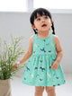 Flat lay of an Annie brand girls sleeveless pink frock featuring a gently gathered waist and an all-over magical print with white and blue unicorns, fairies, rainbows, clouds, and stars.