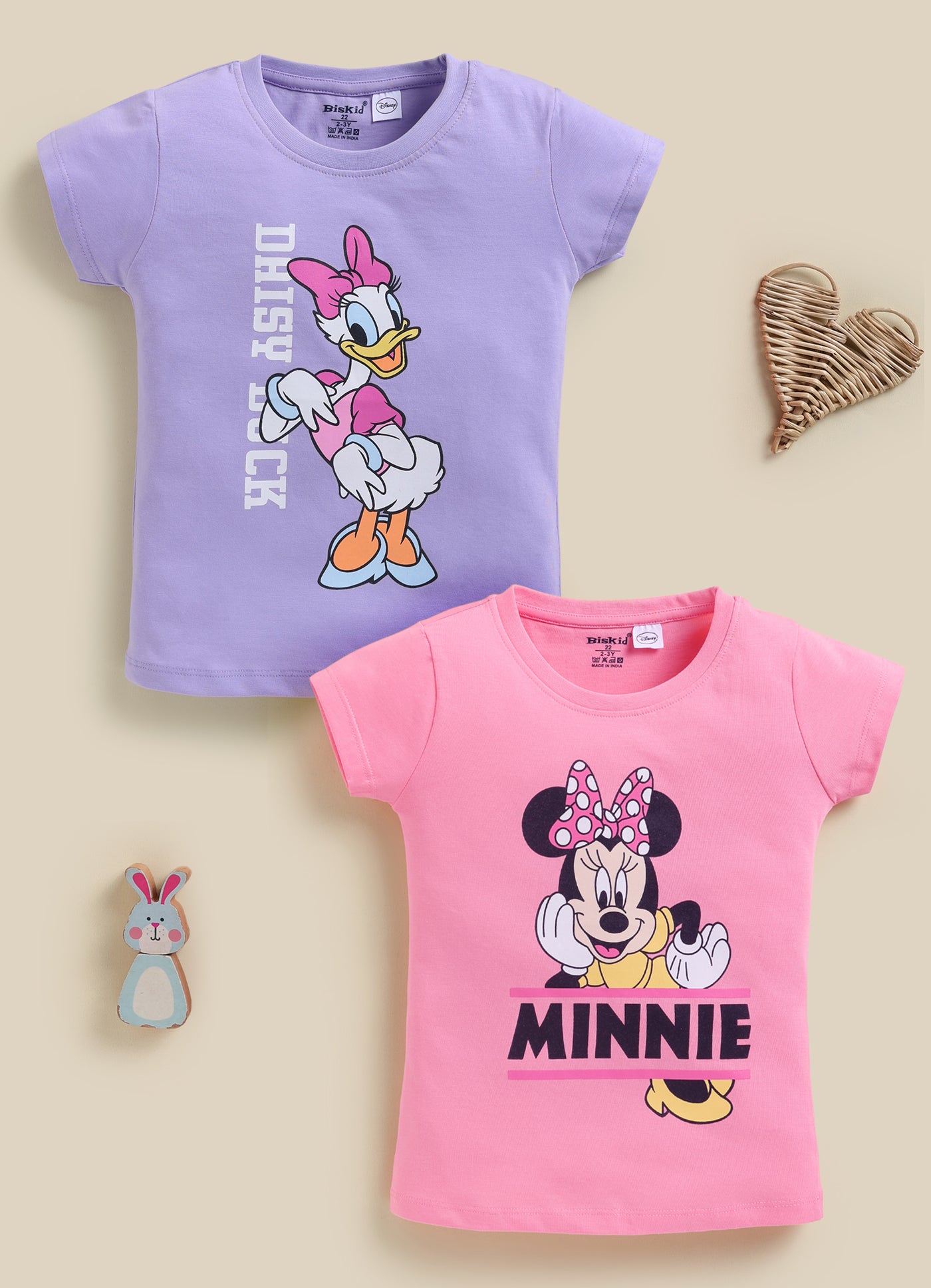 Image file 1819-Pch--1819-Prpl.jpg showing a 2-pack of Biskid girls short-sleeve tops featuring Disney prints, including a purple Daisy Duck top and a peach Minnie Mouse top.
