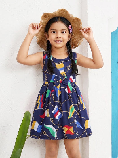 Annie brand girls sleeveless navy blue frock featuring a gently gathered waist with a matching center bow and an all-over nautical print of golden ropes and colorful signal flags.