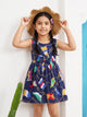 Annie brand girls sleeveless navy blue frock featuring a gently gathered waist with a matching center bow and an all-over nautical print of golden ropes and colorful signal flags.