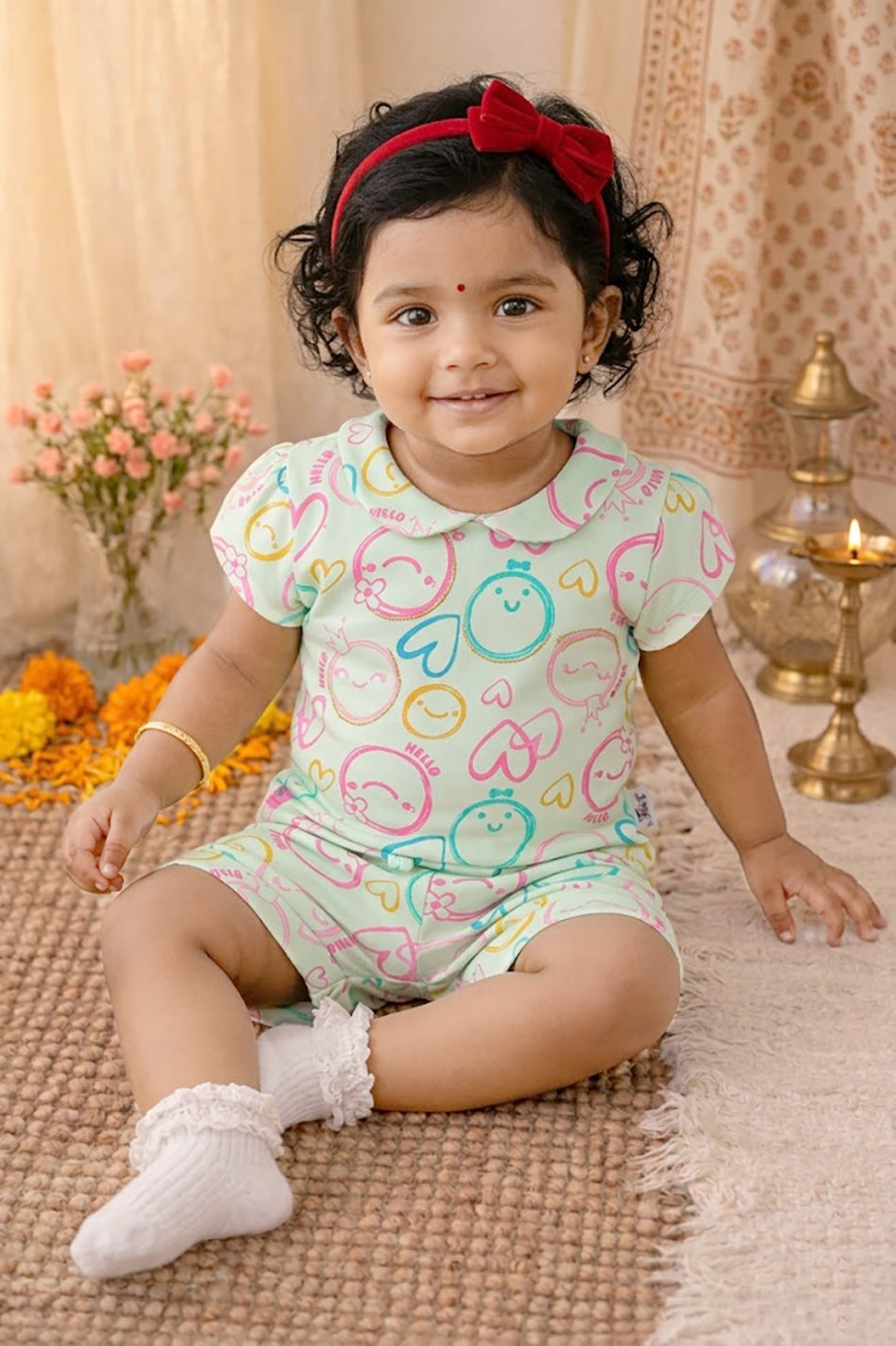 Annie brand girls two-piece clothing set featuring a pale lemon short-sleeve top with a Peter Pan collar and matching shorts. Both pieces feature an all-over pastel print of doodle smiley faces, hearts, and the word HELLO in pink, blue, and yellow. The shorts have an elastic drawstring waist and front pockets.