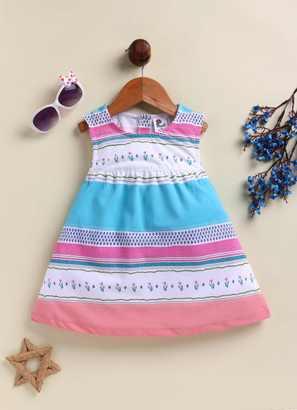 Flat lay of an Annie brand girls sleeveless frock featuring a gently gathered waist and colorful horizontal stripes in bright blue pink teal and white decorated with small floral and geometric patterns.