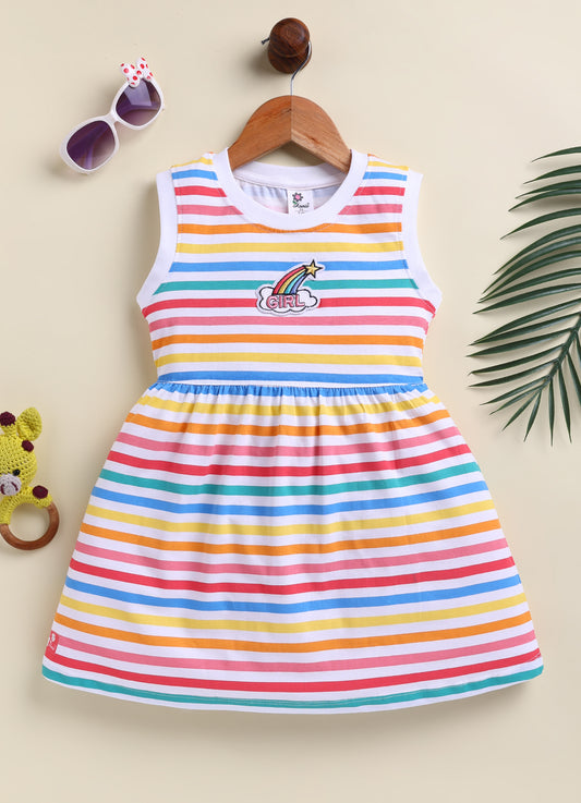 Flat lay of an Annie brand girls sleeveless frock featuring multi-colored horizontal rainbow stripes on a white background and an embroidered rainbow and cloud patch reading GIRL on the chest.