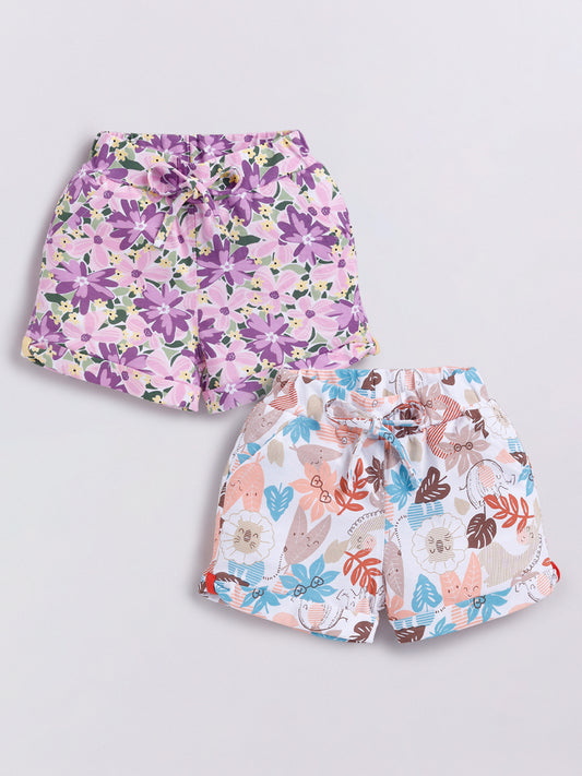Image file Front combo_3.jpg showing a 2-piece set of Biskid brand girls' casual shorts; one pair features a vibrant purple-toned floral print, and the other features a whimsical animal and leaf print on a white background, both with cuffed hems and drawstring waists.