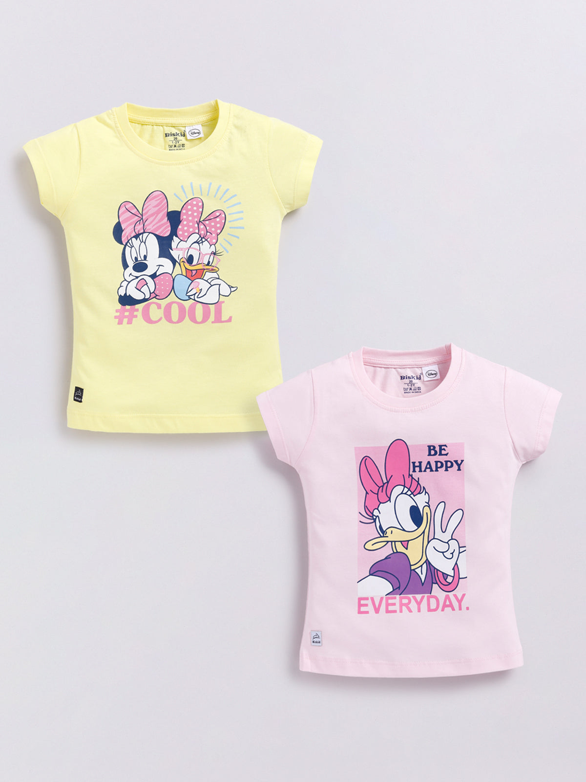 Image file Front combo_9.jpg showing a 2-piece set of Biskid brand girls' casual t-shirts; one is yellow with a Minnie Mouse and Daisy Duck "#COOL" graphic, and the other is pink with a Daisy Duck "BE HAPPY EVERYDAY" graphic, both featuring the Biskid brand label on the bottom hem.