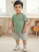 Image file _MG_5127 Colour Correction (4).jpg showing a flat lay of an olive green Biskid brand boys short-sleeve t-shirt featuring a Captain America graphic, his shield logo, and contrasting black and red neck trim.