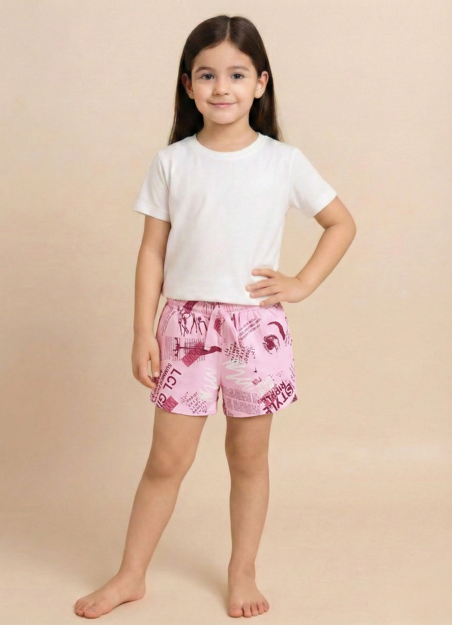 Image file IMG_0363.jpg showing a pair of Biskid brand light pink girls shorts featuring an all-over print of typographic elements, including "STYLE" text and fashion-related inspirational quotes, with an elastic waistband.