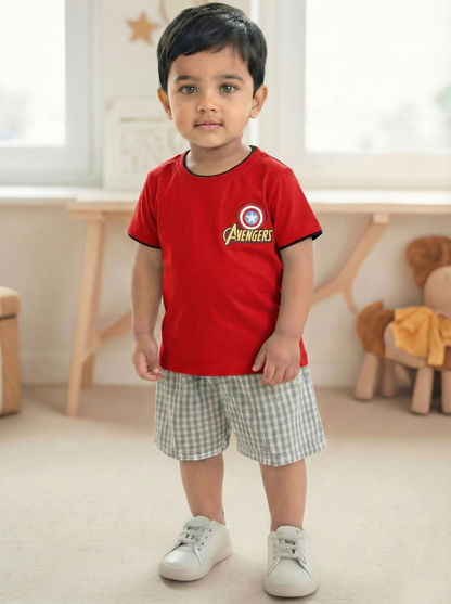 Image file _MG_5120.jpg showing a flat lay of a red Biskid brand boys short-sleeve t-shirt featuring an "AVENGERS" graphic, the Captain America shield logo, and contrasting black and yellow neck trim.