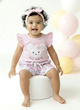 Annie brand girls two-piece clothing set featuring a soft peach flutter-sleeve top with a mouse graphic, 3D flower applique, and the text "happy little me", paired with white shorts featuring a beautiful peach floral print, cuffed hems, and a ruffled elastic waist.