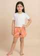 Image file 1409-Peach.jpg showing a pair of Biskid brand peach girls shorts with an elastic drawstring waistband, covered in an all-over beach-themed typography print featuring words like "SWEET" and "COMFORT," with a small "BISKID" brand tag on the side.