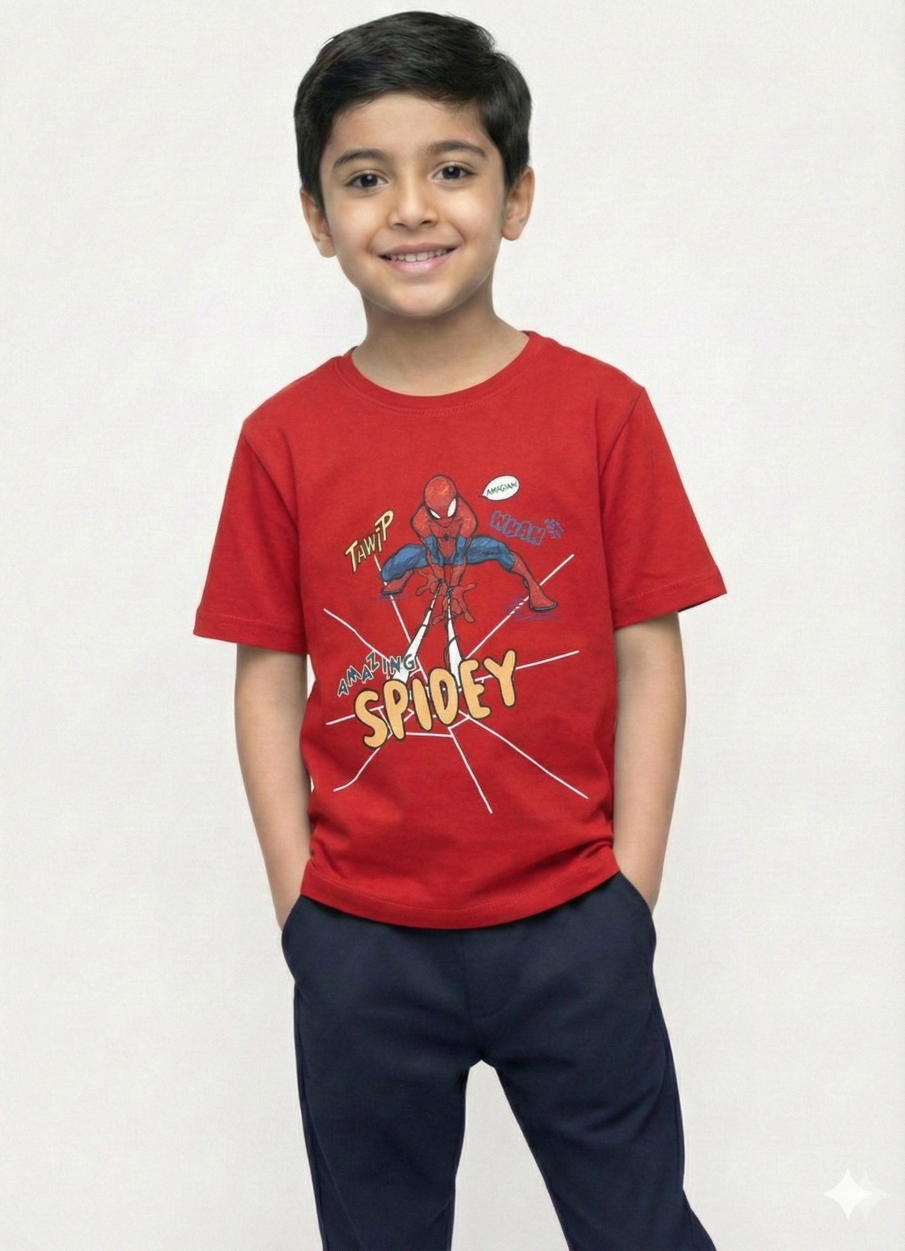 showing a smiling young boy with dark hair modeling a bright red Biskid brand short-sleeve t-shirt. The shirt features an action graphic of Spider-Man crouching and shooting webs, surrounded by the text "AMAZING SPIDEY" and comic-style sound effect words.