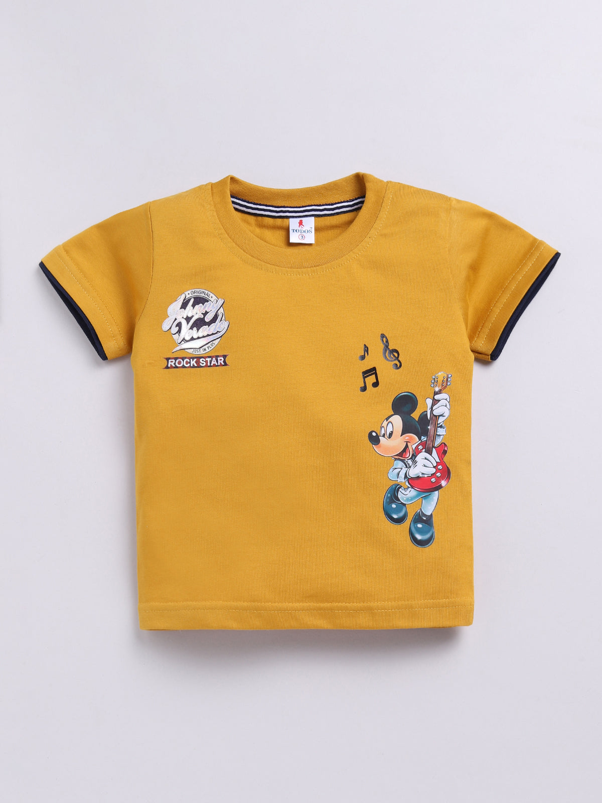 showing a flat lay of a Todos brand boys two-piece clothing set. The outfit features a mustard yellow short-sleeve t-shirt with a graphic of Mickey Mouse playing a guitar and "ROCK STAR" text, paired with dark wash denim shorts featuring an elastic waistband, a mustard yellow drawstring, front pockets, and a "ROCKSTAR" patch on the left leg.