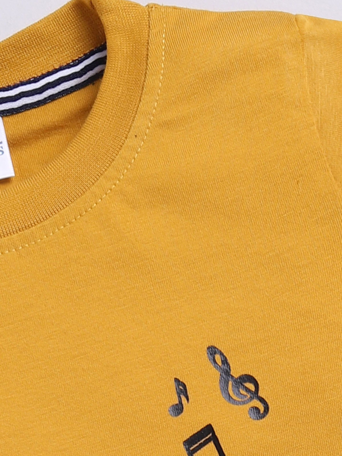 showing a flat lay of a Todos brand boys two-piece clothing set. The outfit features a mustard yellow short-sleeve t-shirt with a graphic of Mickey Mouse playing a guitar and "ROCK STAR" text, paired with dark wash denim shorts featuring an elastic waistband, a mustard yellow drawstring, front pockets, and a "ROCKSTAR" patch on the left leg.