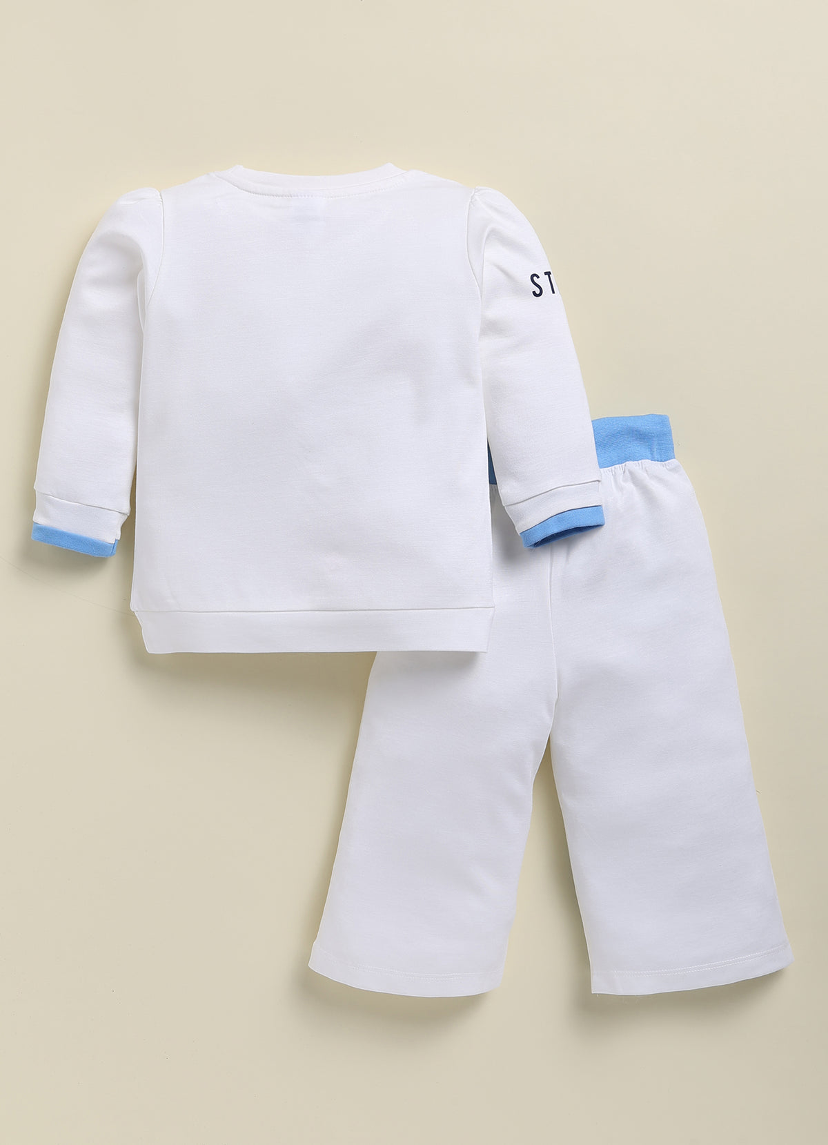 Annie white and light blue sporty clothing set for girls featuring a long-sleeve sweatshirt with a "Just Love You" graphic and matching jogger pants with color-blocked details and text prints.