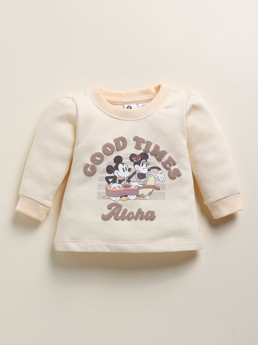 Image showing a flat lay of an Annie brand girls two-piece clothing set. The outfit includes a brown long-sleeve top with a "COSMIC FLOWERS" graphic showing planets shaped like flowers, paired with off-white joggers featuring an all-over print of colorful, detailed planets.