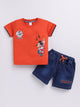 showing a flat lay of a Todos brand boys two-piece clothing set. The outfit features a bright orange short-sleeve t-shirt with a graphic of Mickey Mouse playing a guitar and "ROCK STAR" text, paired with dark wash denim shorts featuring an elastic waistband, an orange drawstring, front pockets, and a "ROCKSTAR" patch on the left leg.
