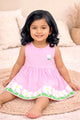 Flat lay of an Annie brand girls sleeveless pink and white striped frock featuring a small flower patch on the chest and a border of large white flowers with green leaves along the bottom hem.