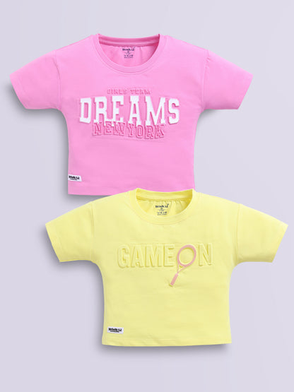 Image file d.pink_lemon.jpg showing a 2-pack of Biskid girls short-sleeve casual crop tops featuring embossed typographic prints, including a dark pink "DREAMS NEW YORK" top and a lemon yellow "GAME ON" top.