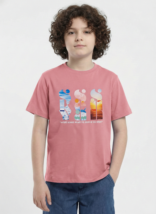 a young boy with curly hair modeling a dusty pink Biskid brand short-sleeve t-shirt. The shirt features an artistic chest graphic with the words "SKY", "SEA", and "SUN" written vertically and filled with nature photography, positioned above the quote "NATURE ALWAYS WEARS THE COLORS OF THE SPIRIT".
