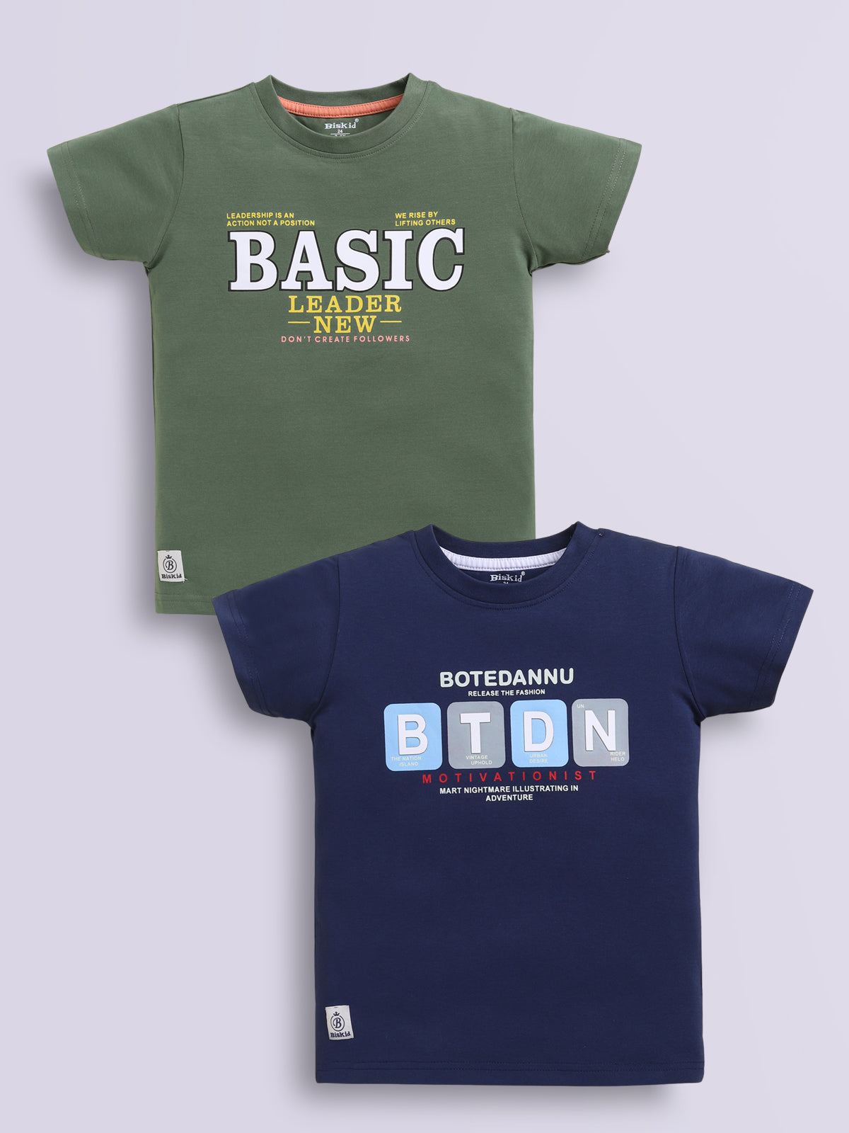 Image file navy_m.green.jpg showing a 2-pack of Biskid boys short-sleeve t-shirts featuring typographic prints, including a green tee with "BASIC LEADER" lettering and a navy blue tee with "BTDN" block letter graphics.