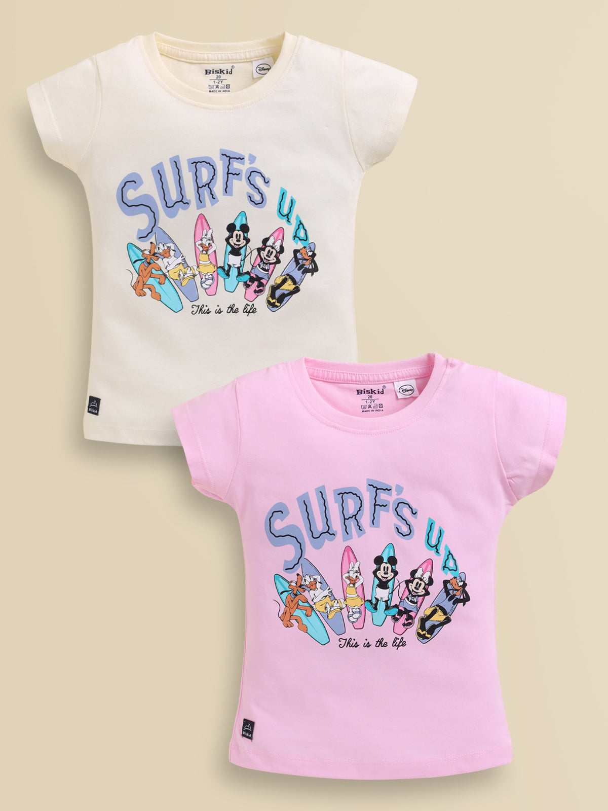 Image file showing a 2-pack of Biskid girls short-sleeve tops featuring Disney prints, including a cream top and a pink top both with a "Surfs Up" character surfboards graphic.